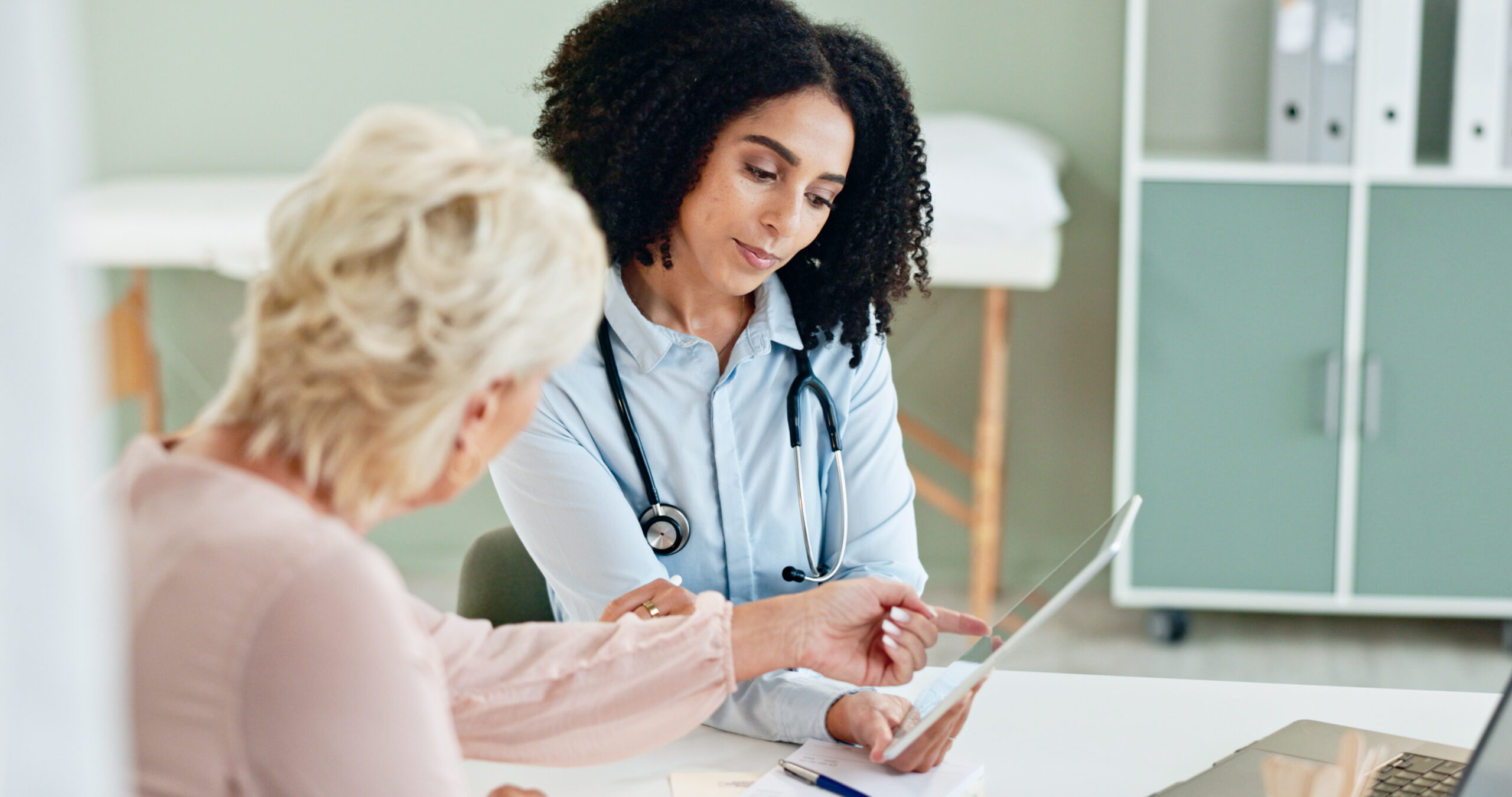 A young doctor and her older patient discussing FROST trial cryoablation results.