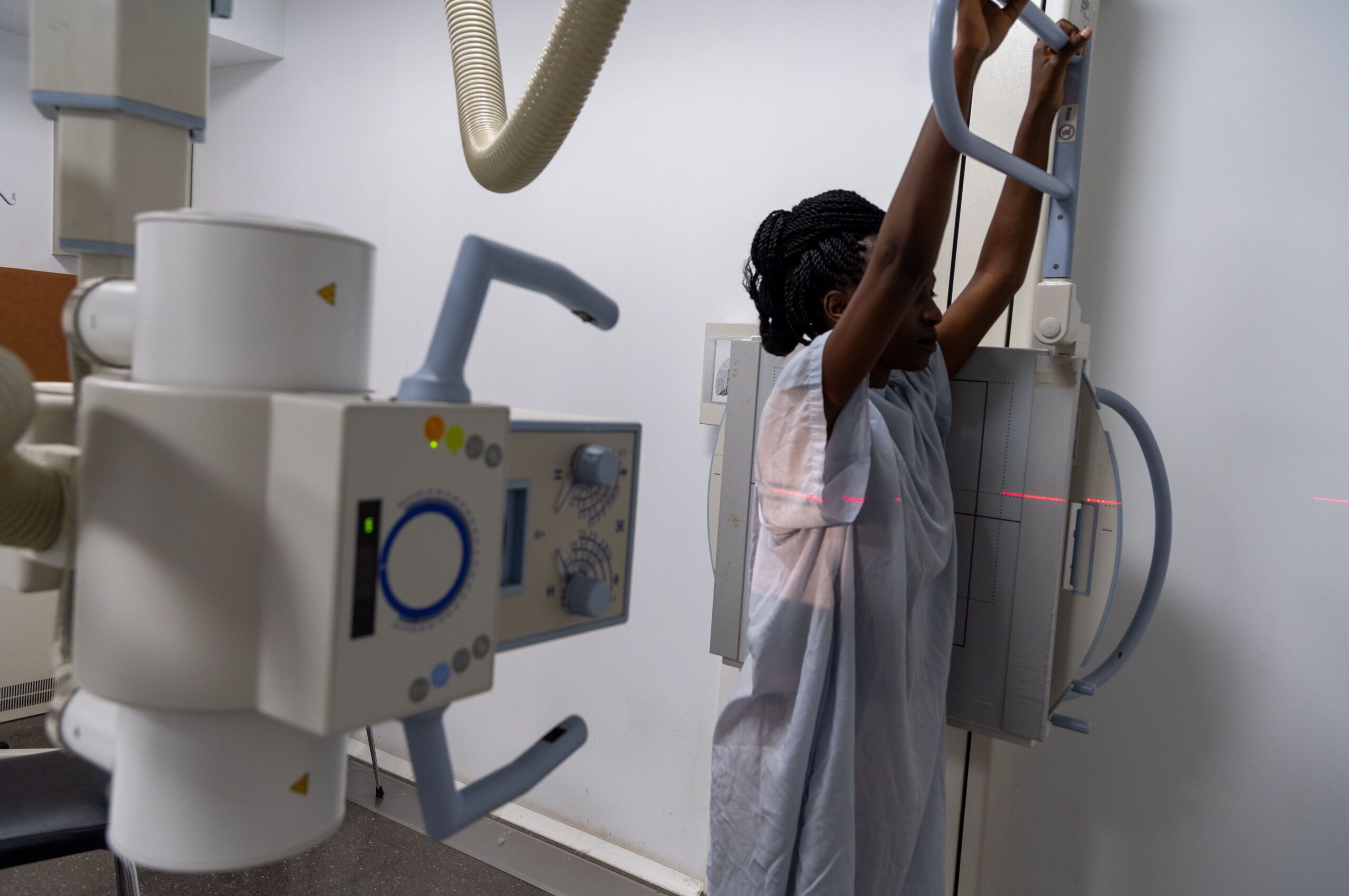 A female patient undergoing a radiology scan at a mammogram clinic