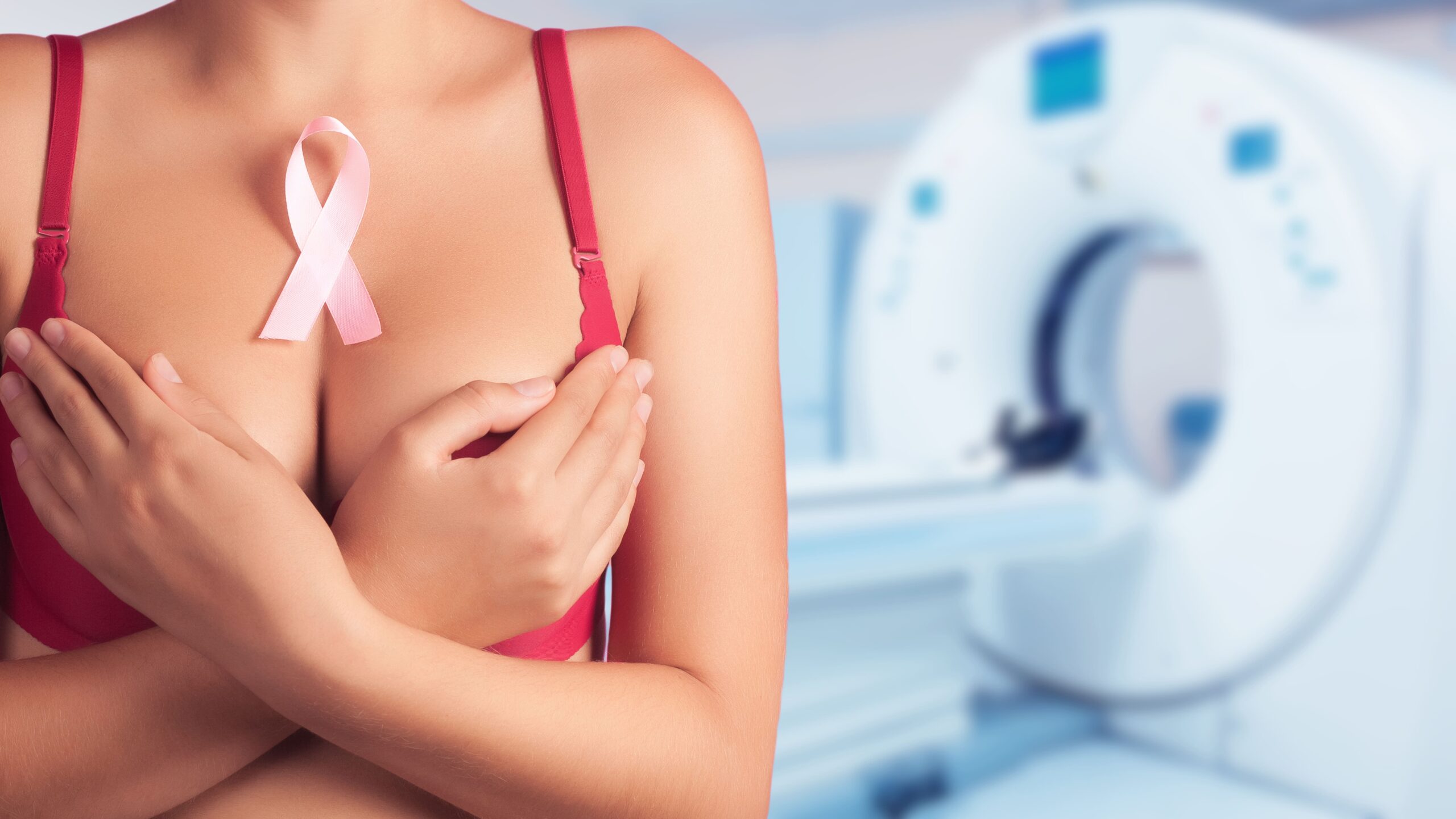 A young lady wearing a red bra and a pink ribbon, in response to “how often should mammograms be done?”